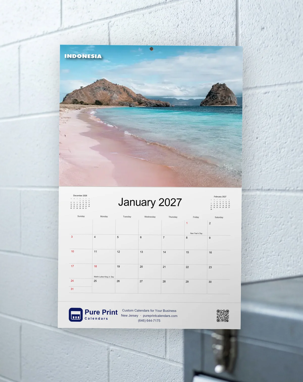 Beaches of the World 2027 calendar open to January, hanging on a wall