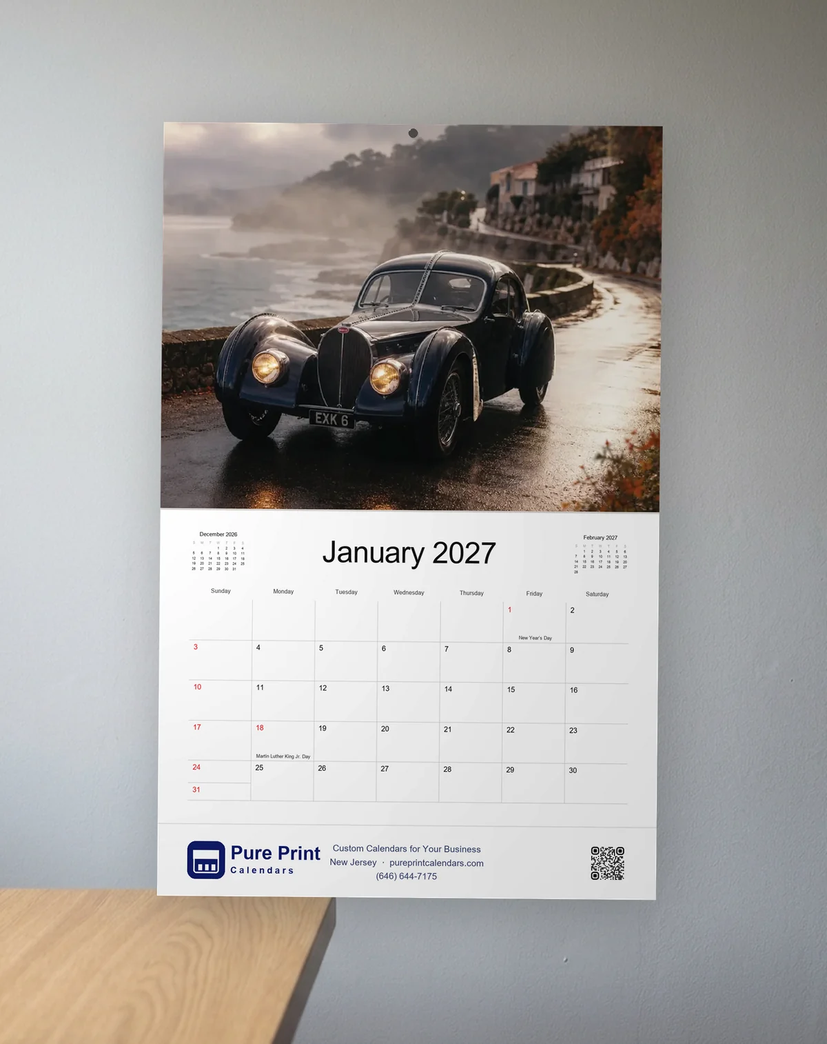 Classic Cars 2027 calendar open to January, hanging on an office wall