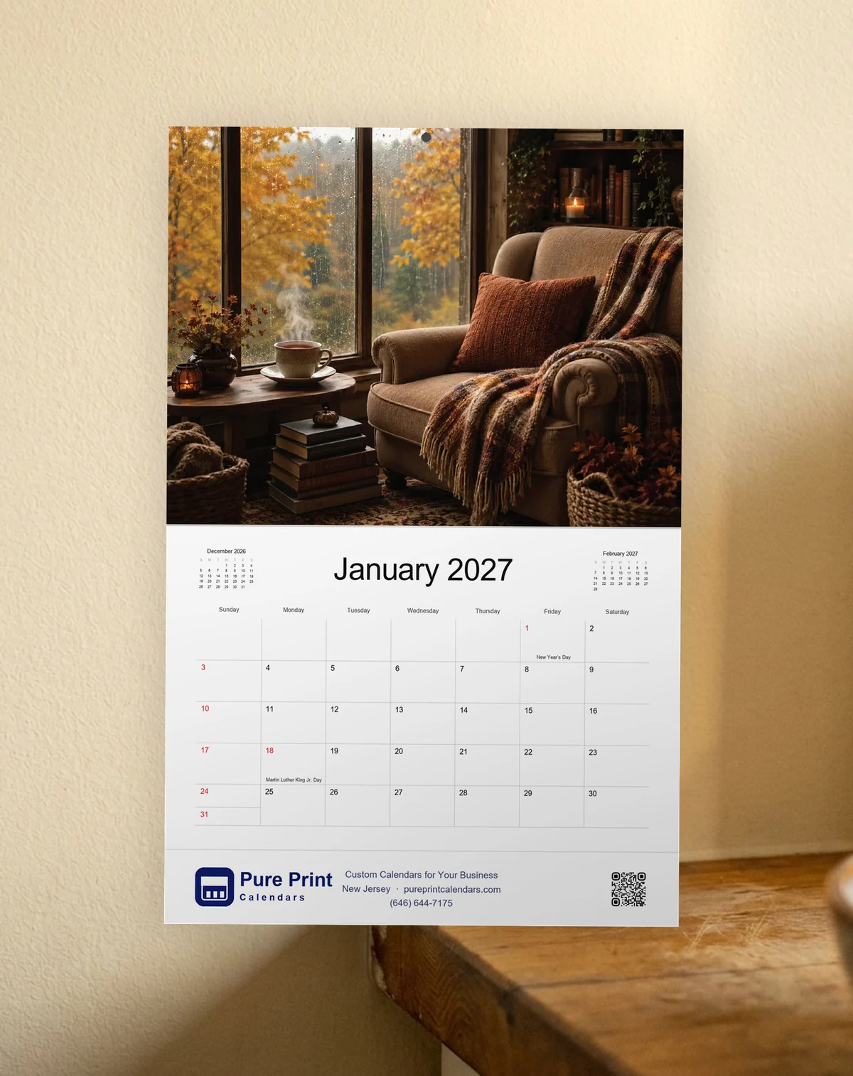 Cozy Days 2027 calendar open to January, hanging on a wall